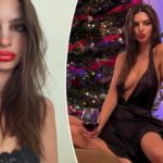 Emily Ratajkowski wears a plunging black satin dress in front of Christmas tree in Instagram post
