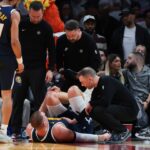 Nuggets’ Nikola Jokic leaves game against Heat before halftime with knee injury