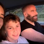 John Travolta celebrates the New Year in spectacular fashion with kids Ella and Benjamin — watch