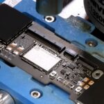 Don’t like the MacBook Neo’s storage options? Well, with lots of electronics gear, years of experience, and nerves of steel, you too can have a 1 TB model